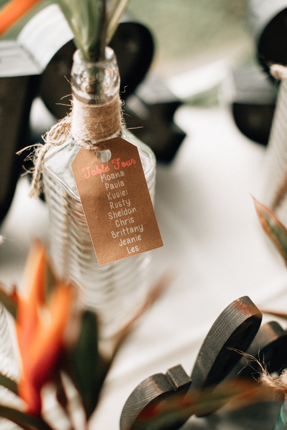 Table Four seating chart on a decorative glass bottle