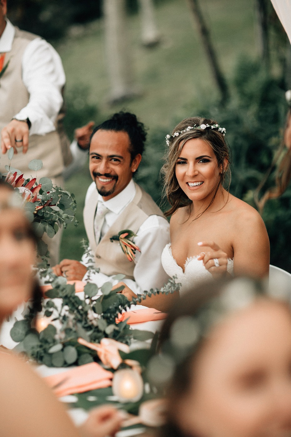 Bride and groom smiling at their outdoor wedding reception