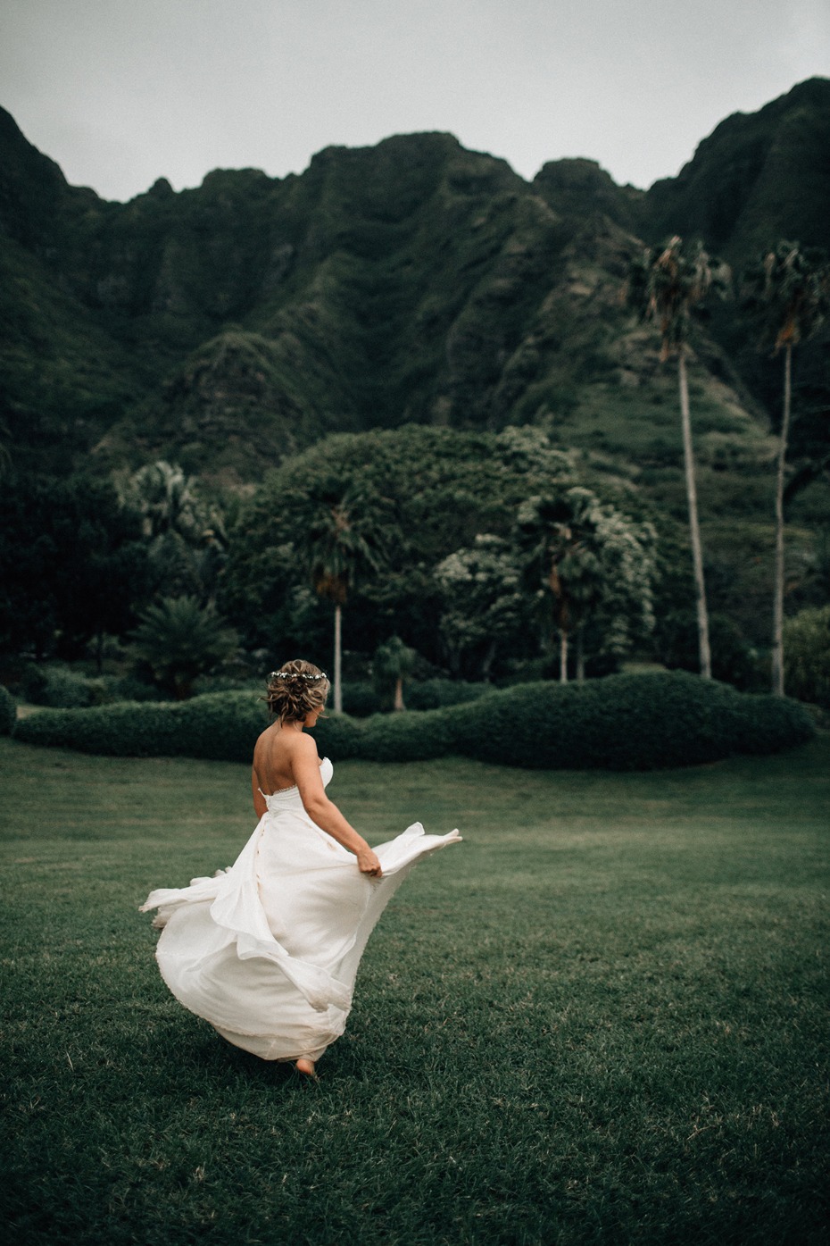 Bride twirling in dress scenic tropical mountain view