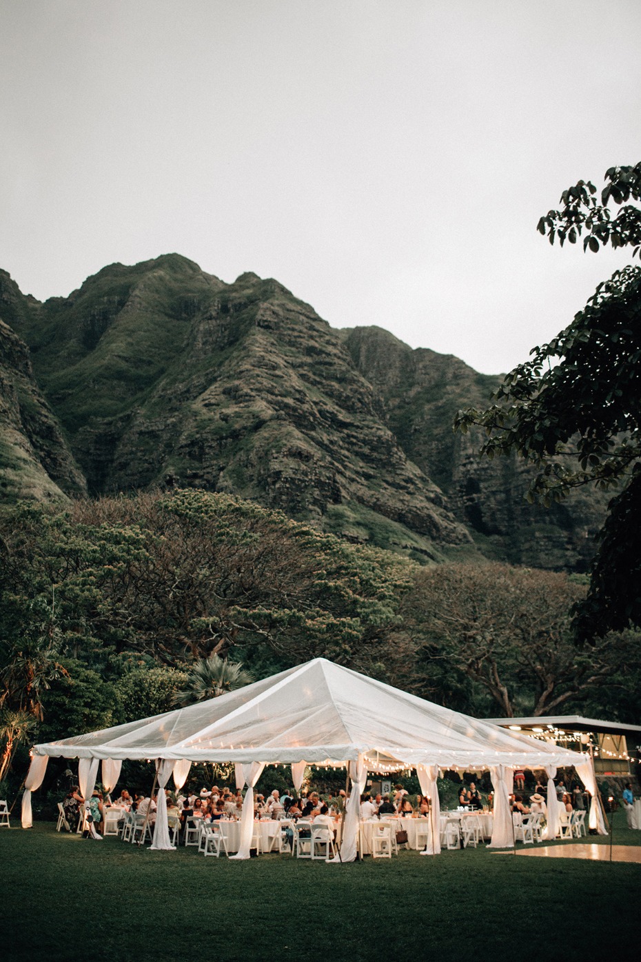 Outdoor wedding reception tent with mountain backdrop