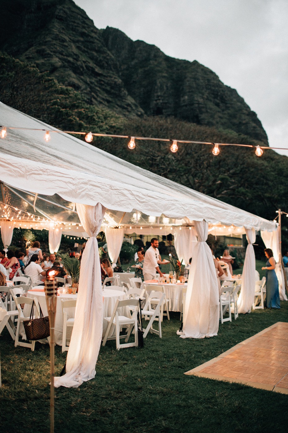 Outdoor wedding reception under tent at mountain location