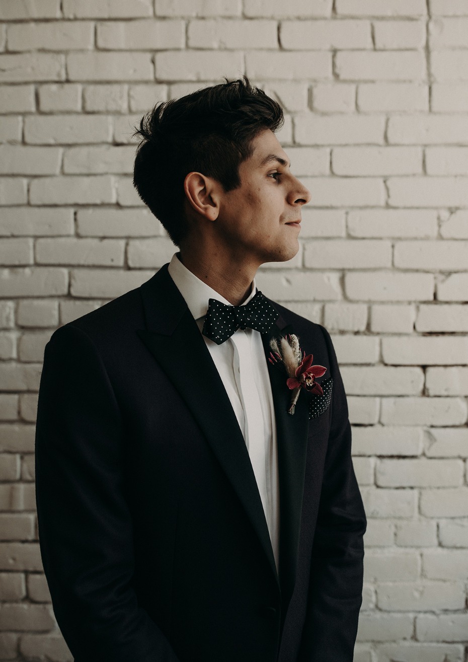 groom in bow tie and suit