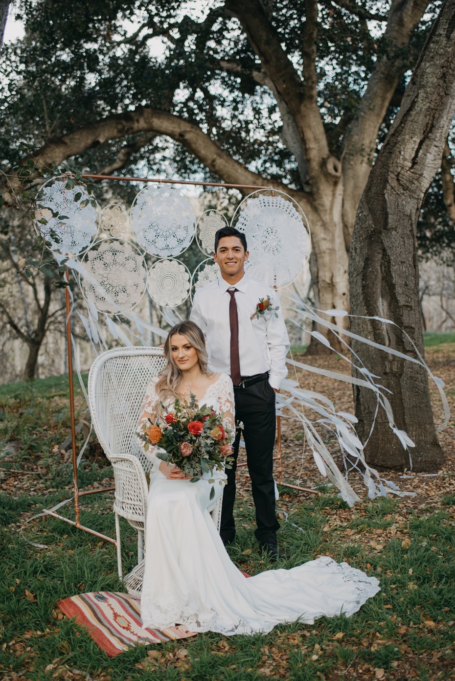 bride and groom with doily dreamcatcher backdrop