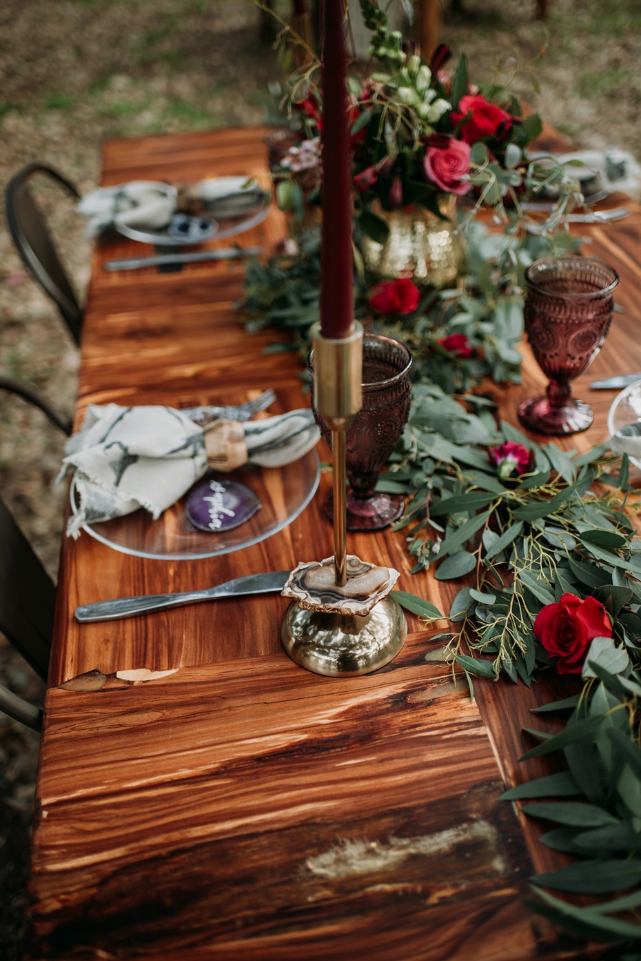 Elegant wood table decor with candles and red roses