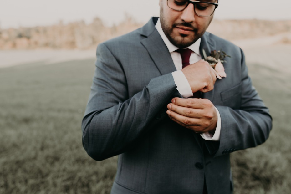 Groom adjusts cuff links before the wedding ceremony