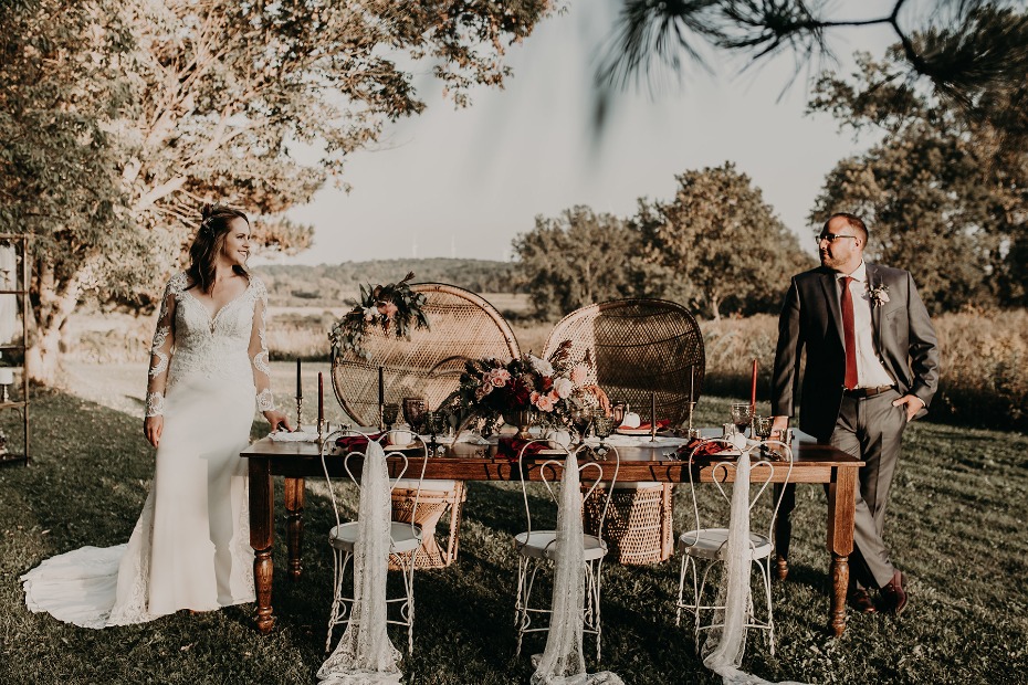Bride and groom at outdoor wedding reception table