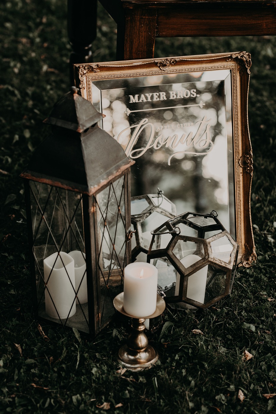Vintage Mayer Bros Donuts sign with lantern candles