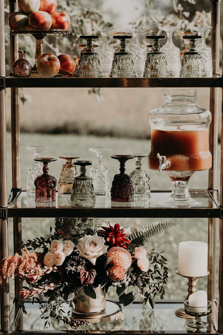 Elegant bar cart decorated with drinks and flowers