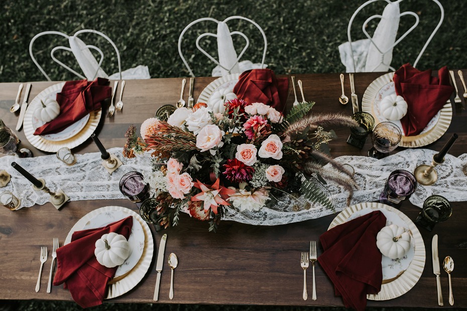 Elegant fall wedding table setting with floral centerpiece