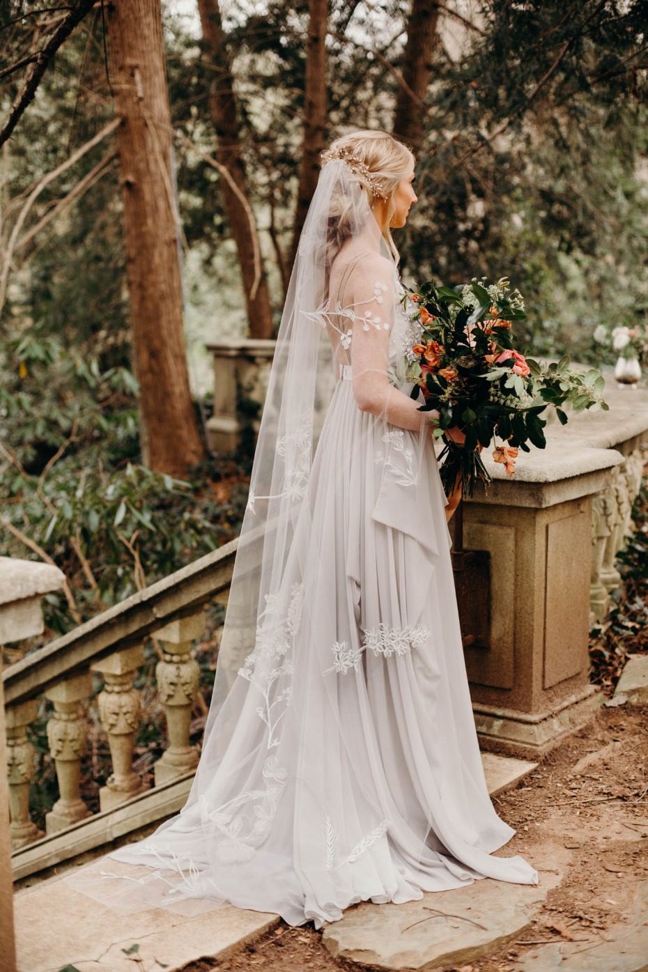 Bride in flowing gown and veil with floral bouquet