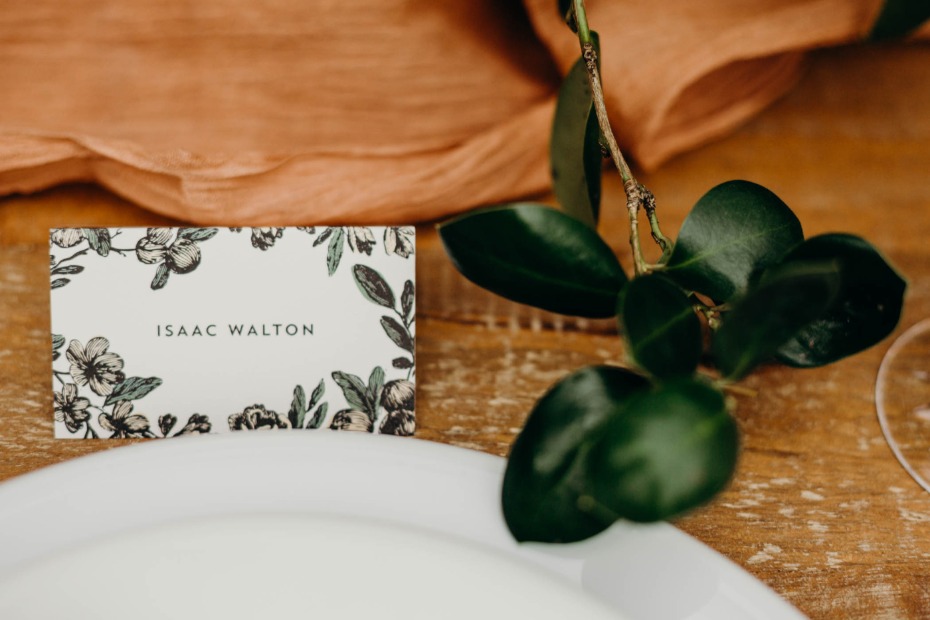 Elegant place card with floral design for Isaac Walton