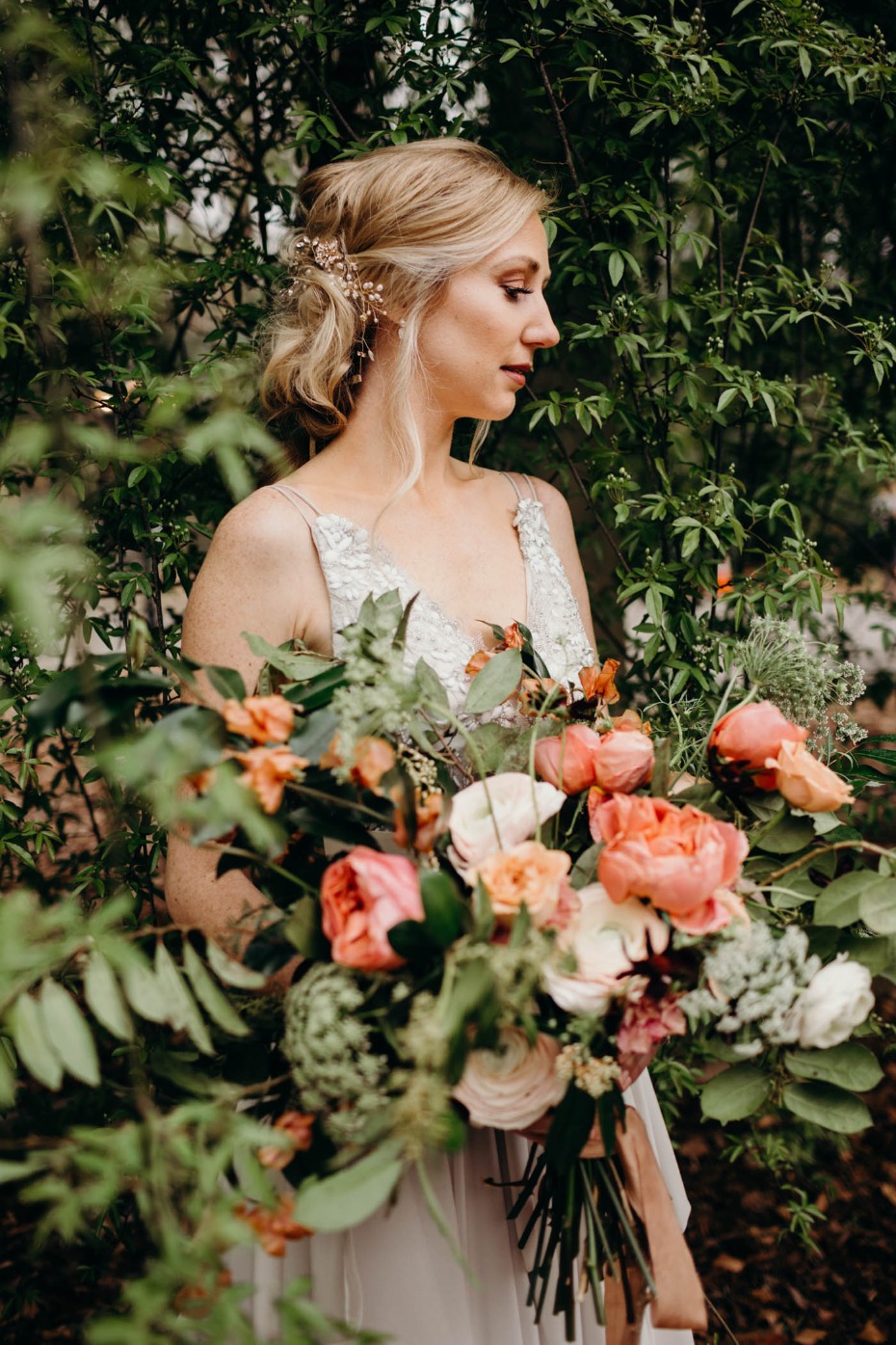 Blonde bride with a vibrant coral and cream bouquet