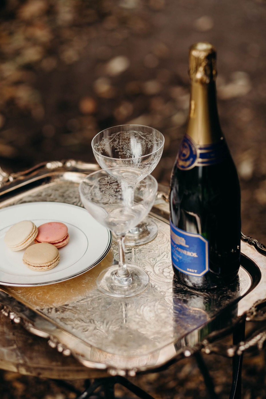 Champagne macarons and glasses on a silver tray