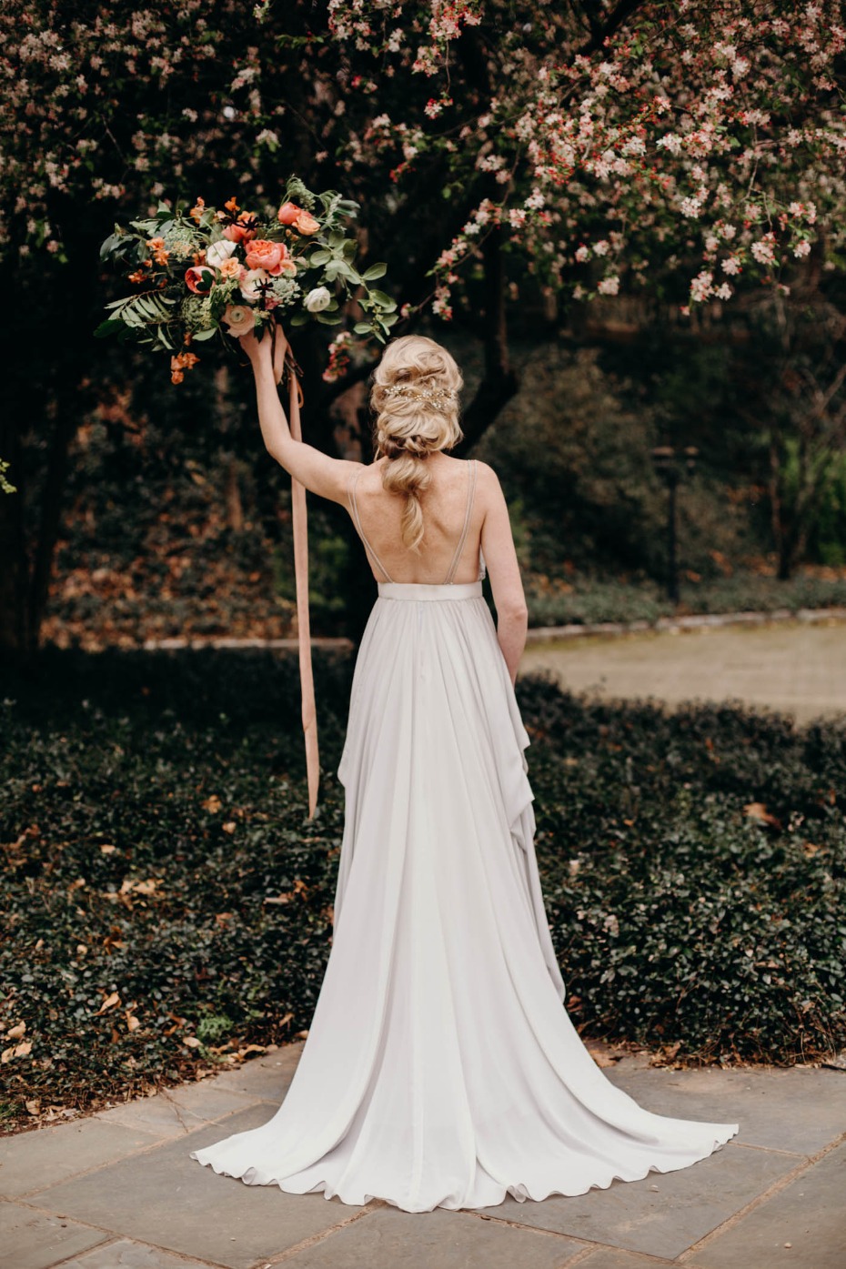 Bride with flowers at outdoor wedding ceremony