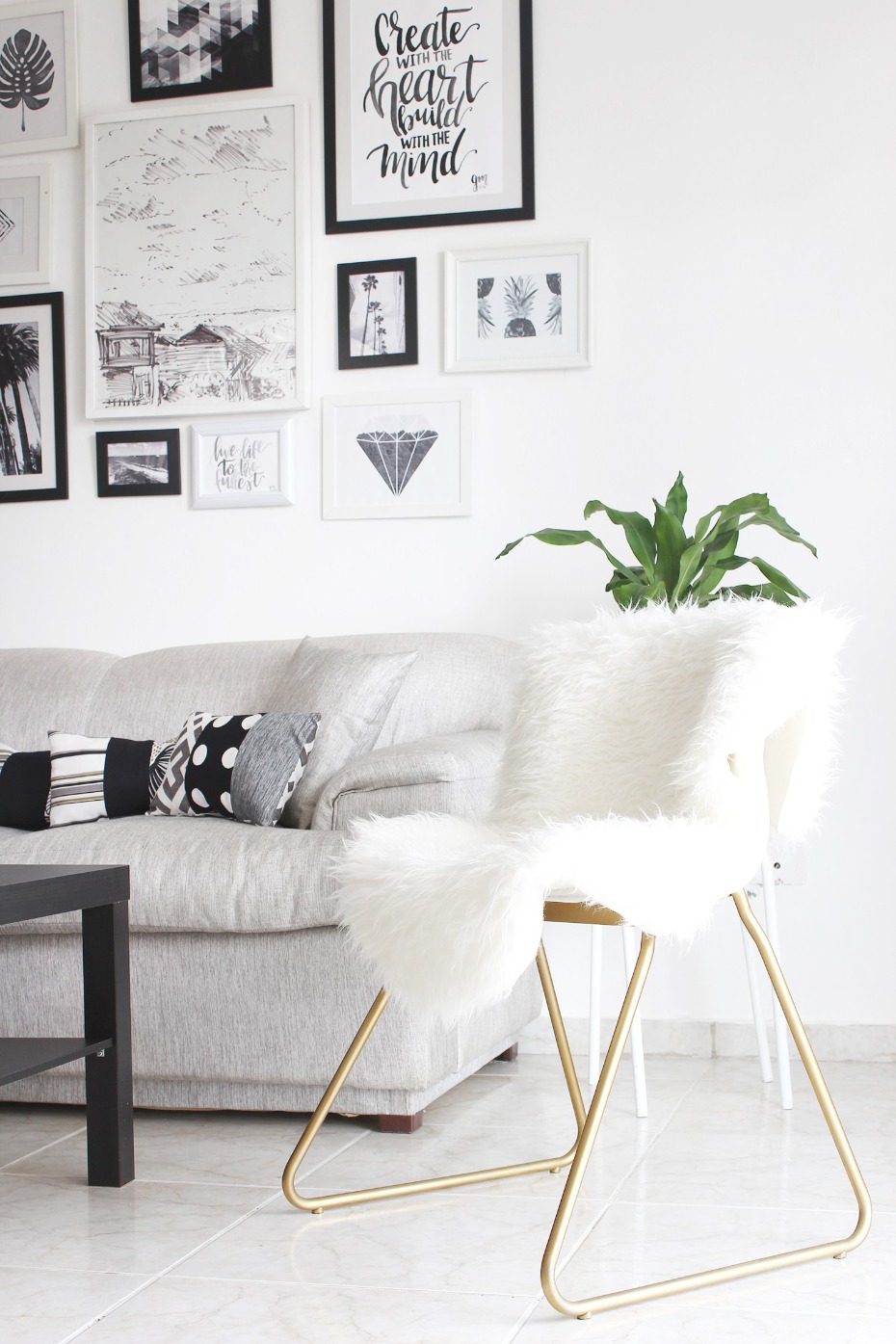 Minimalist living room with gallery wall and furry chair
