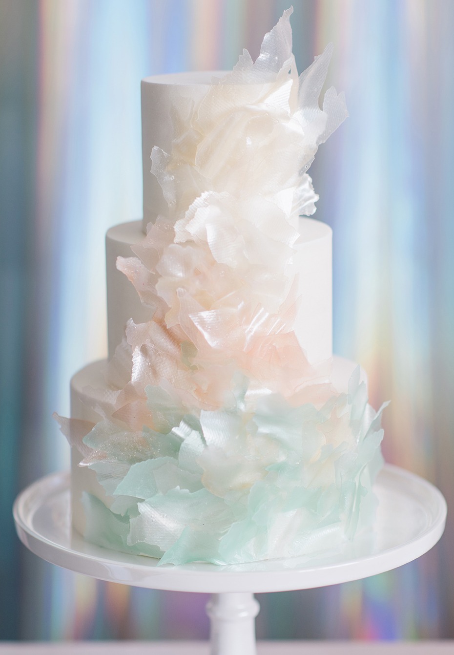 Three tier white cake with pastel wafer paper decor