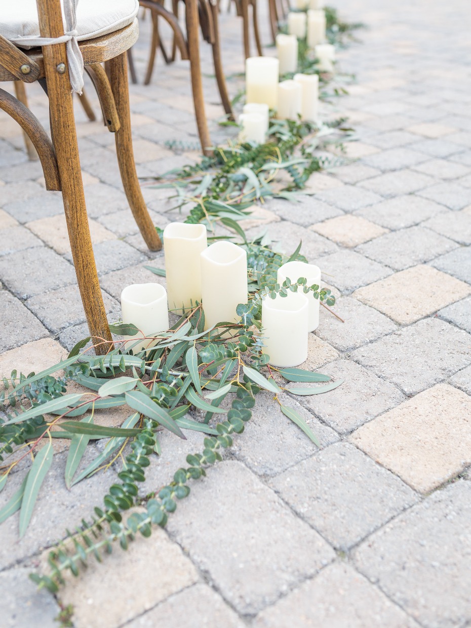 aisle decor idea with greenery and candles