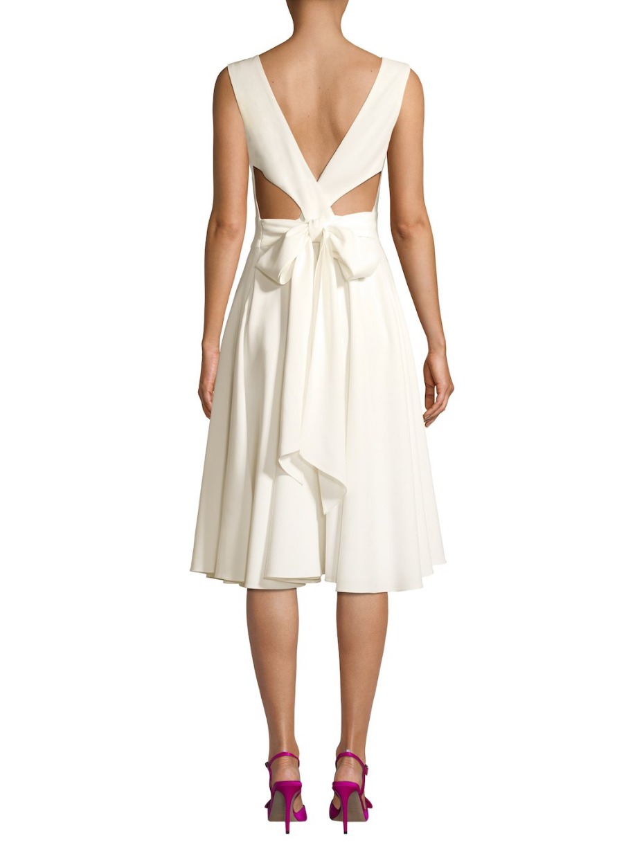 Back view of a white dress with bow detail at the waist