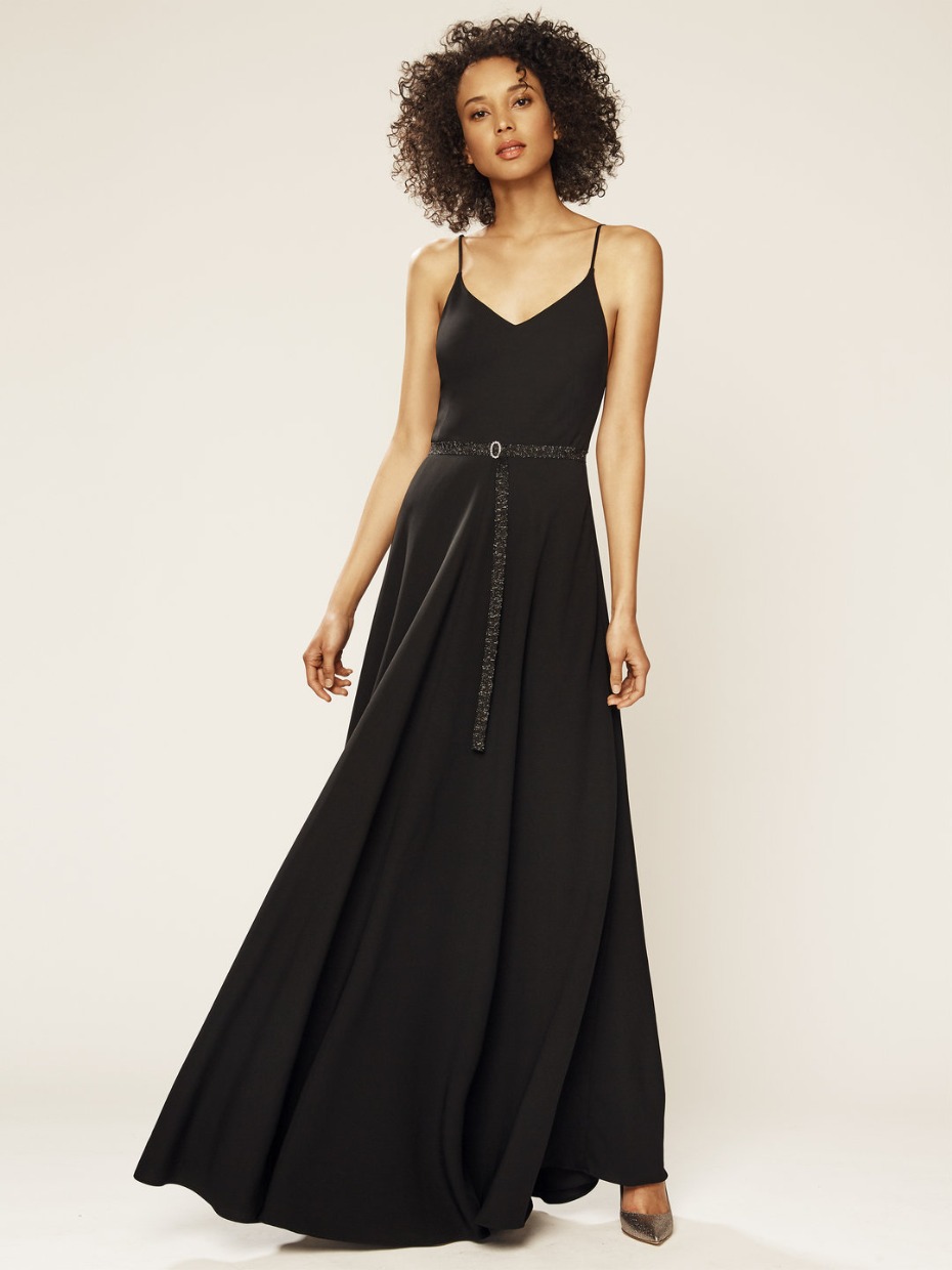Woman in elegant black maxi dress with belt