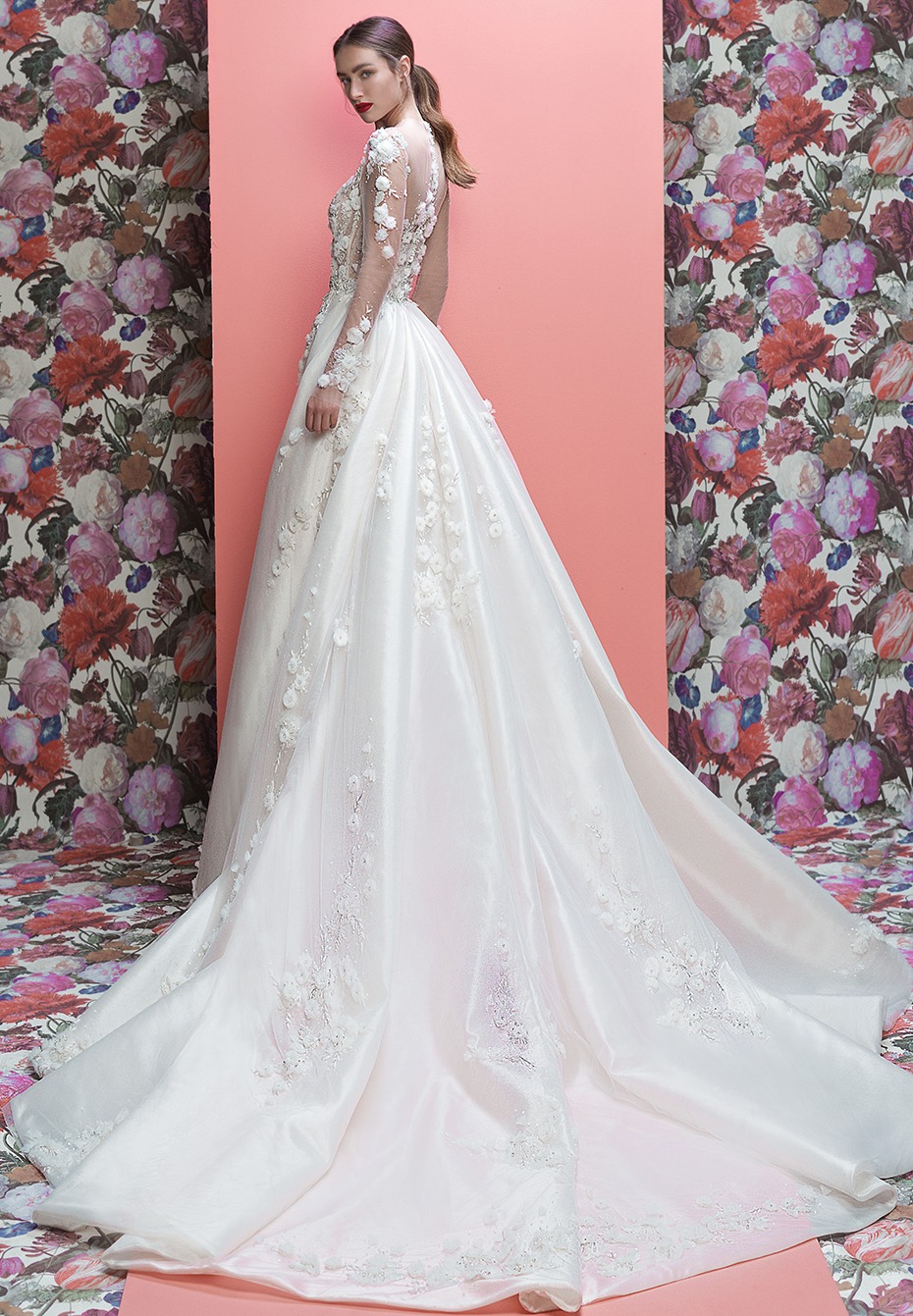 Elegant long sleeved white wedding gown with floral details