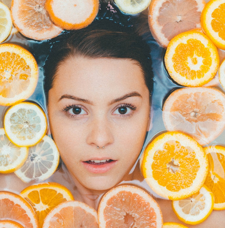 Woman with citrus fruits, skincare, beauty treatment