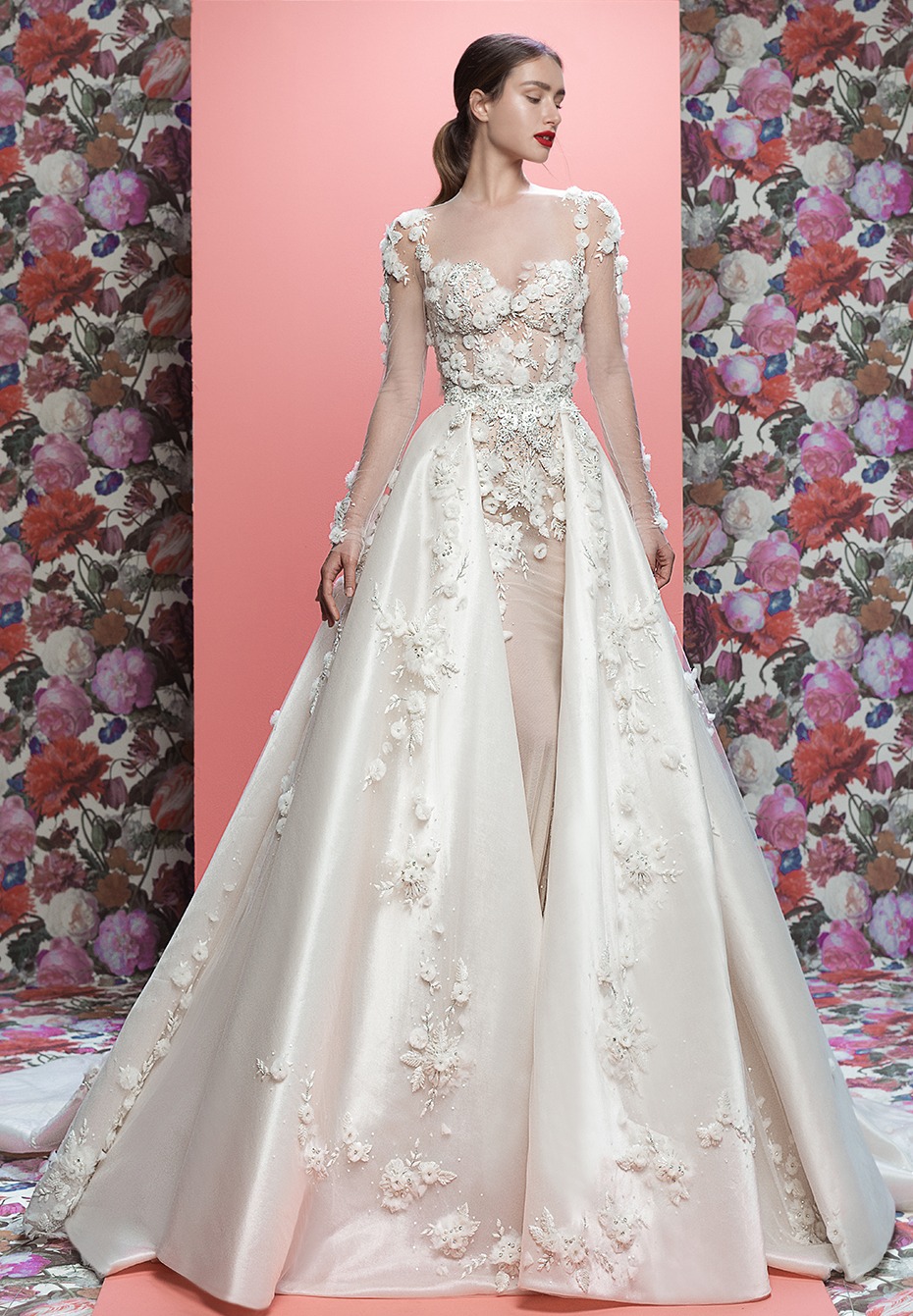Elegant woman wears long sleeved floral wedding gown