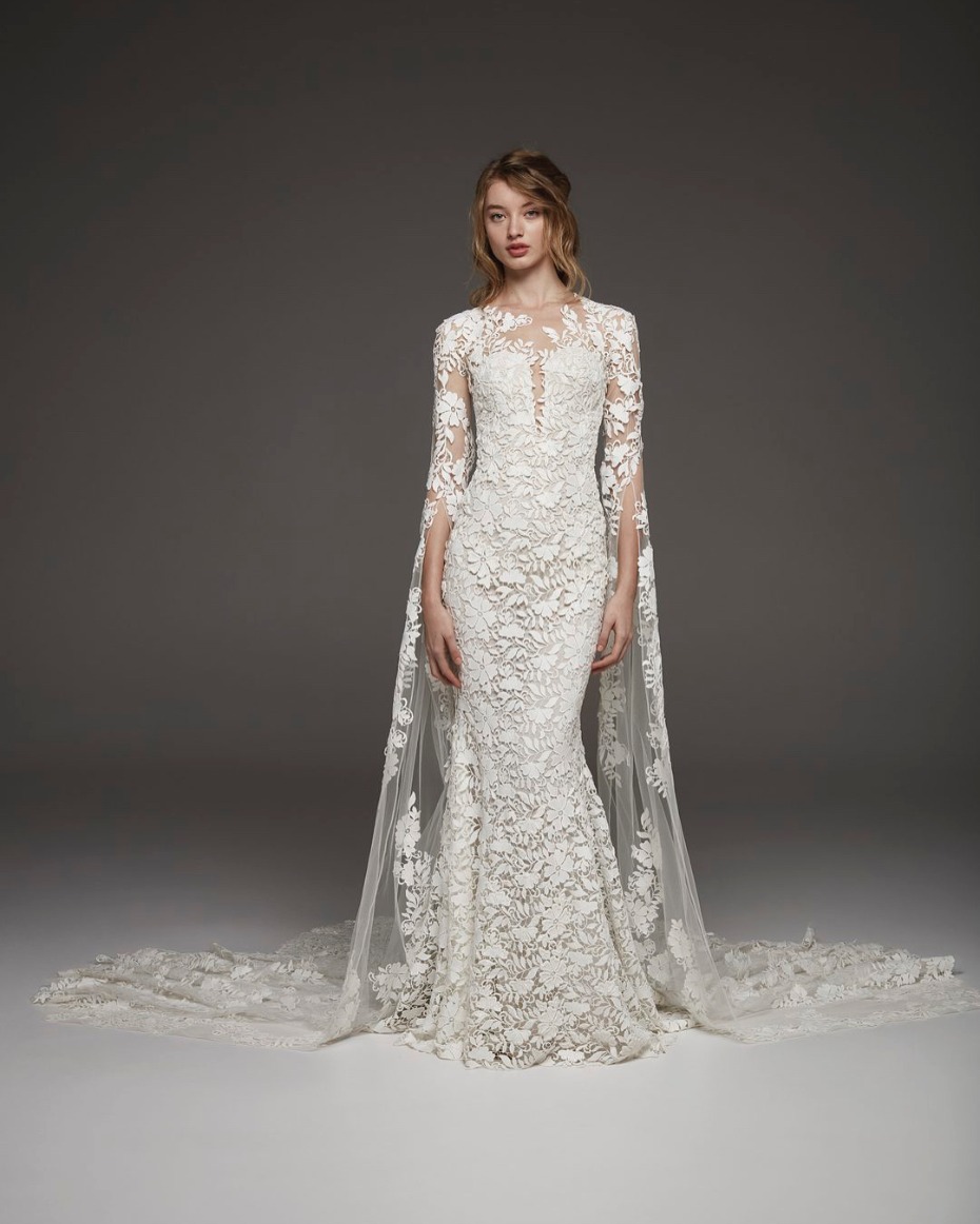 Beautiful white lace wedding dress with flowing cape train