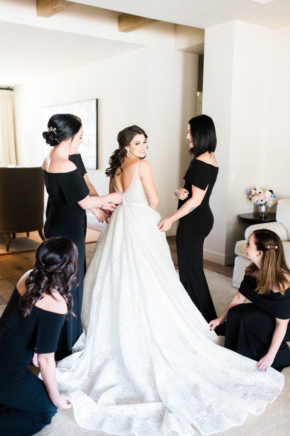 Bride getting ready for wedding with bridesmaids, gown detail