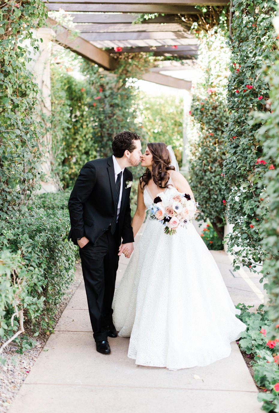 Bride and groom kissing passionately on their wedding day