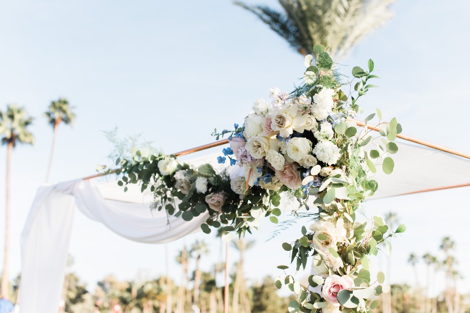 Beautiful floral archway with roses and greenery at a wedding