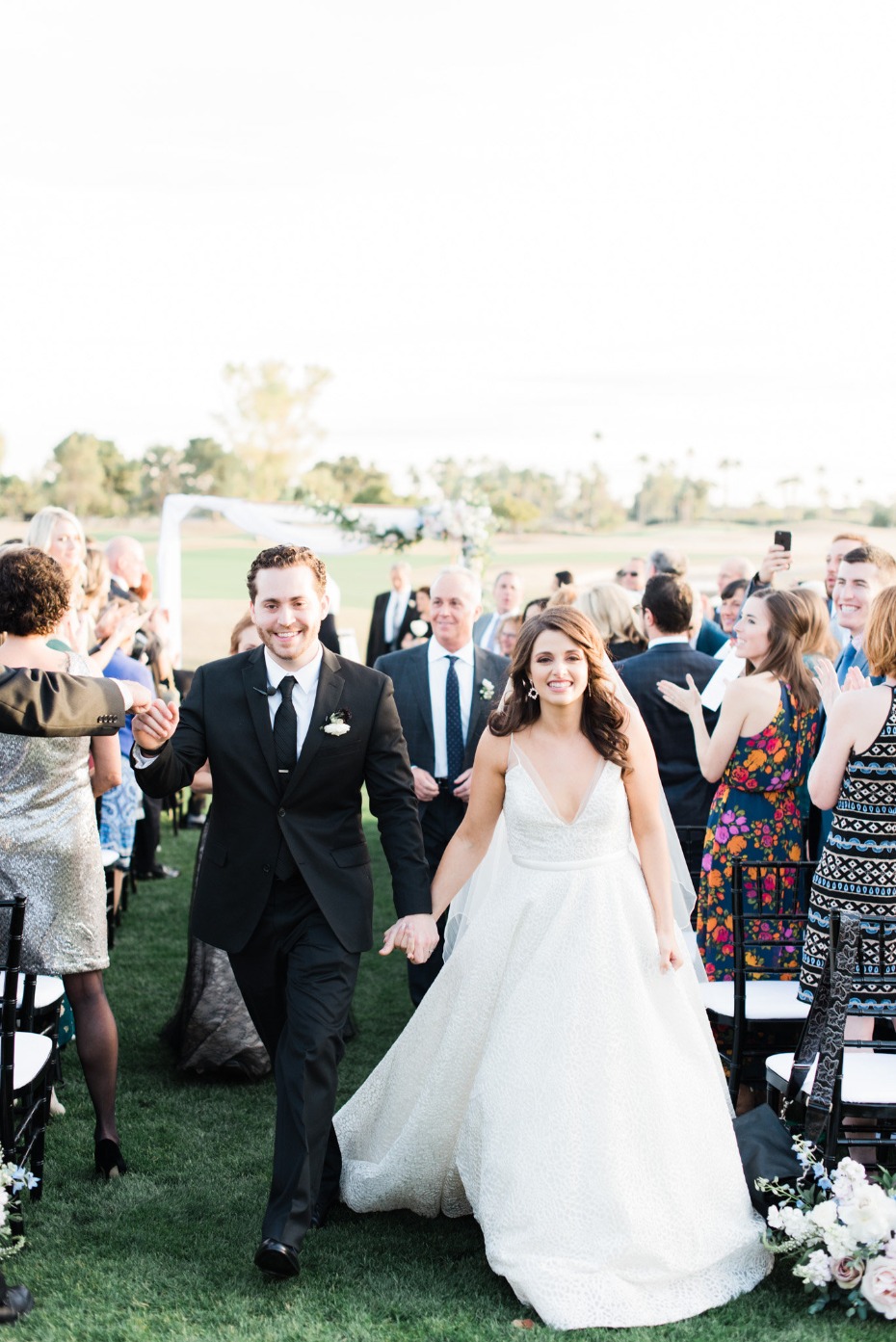 Happy bride and groom walking down the aisle after wedding ceremony