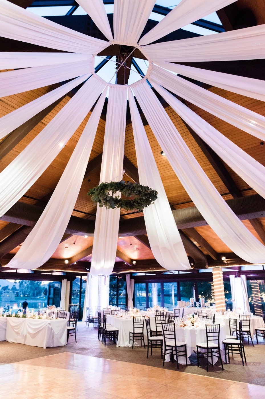 Elegant wedding reception hall with draped white fabric ceiling