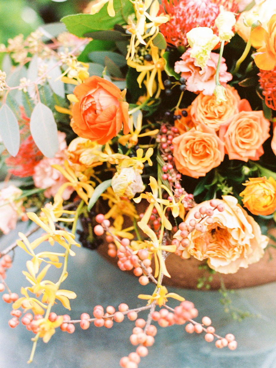 Vibrant orange and yellow wedding floral arrangement