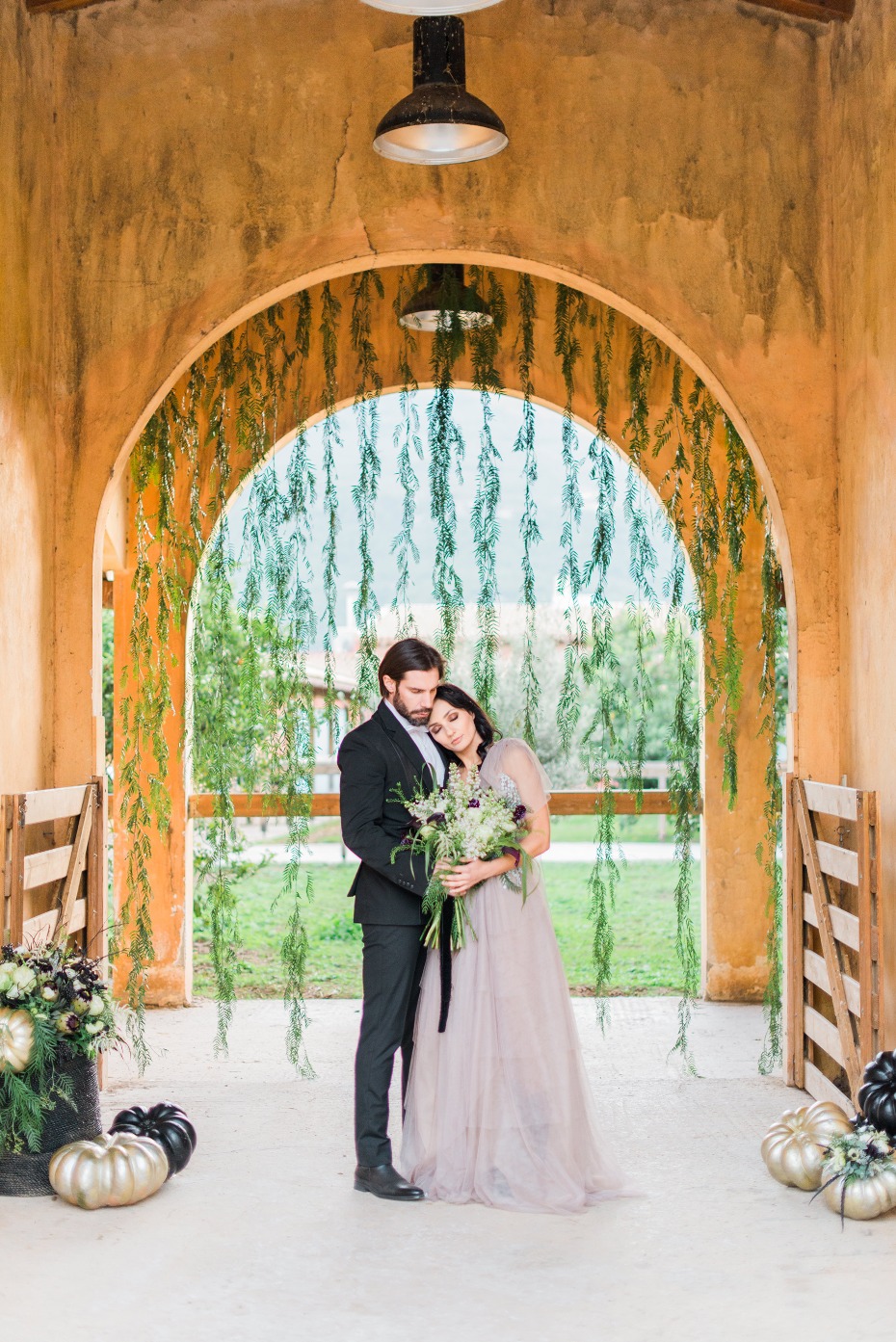 Elegant wedding portrait in rustic Italian style barn
