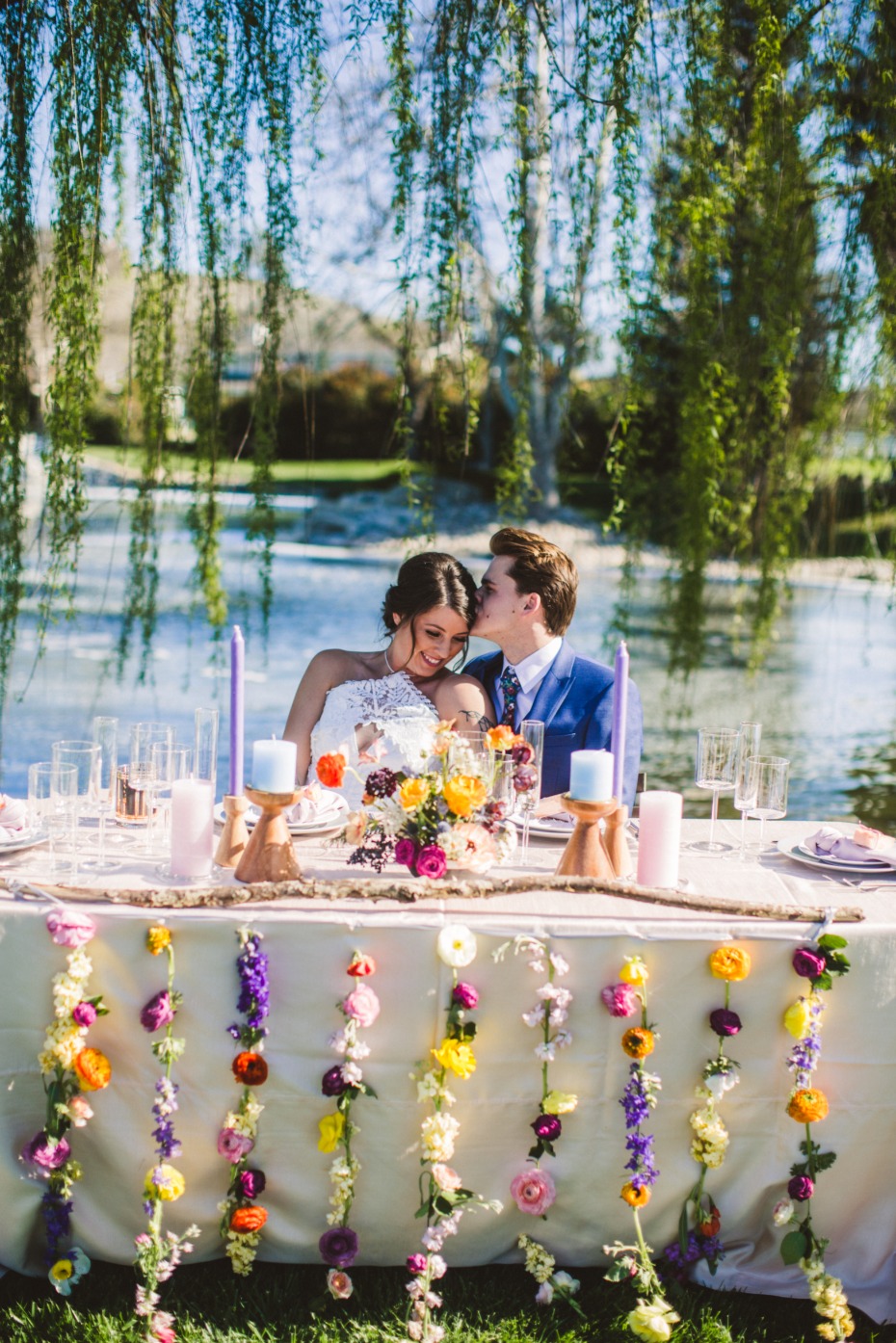 Romantic wedding couple at a floral decorated table