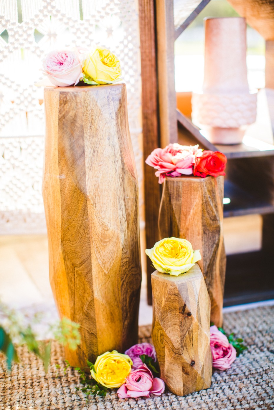 Wooden pedestals adorned with colorful roses display decor