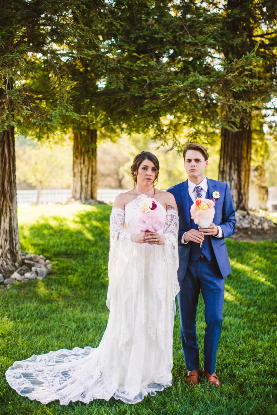 Bride and groom with cotton candy at outdoor wedding