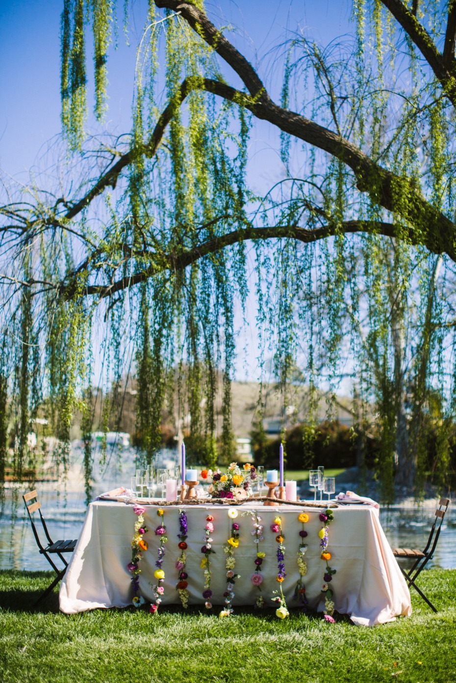 Floral wedding table setting under weeping willow tree