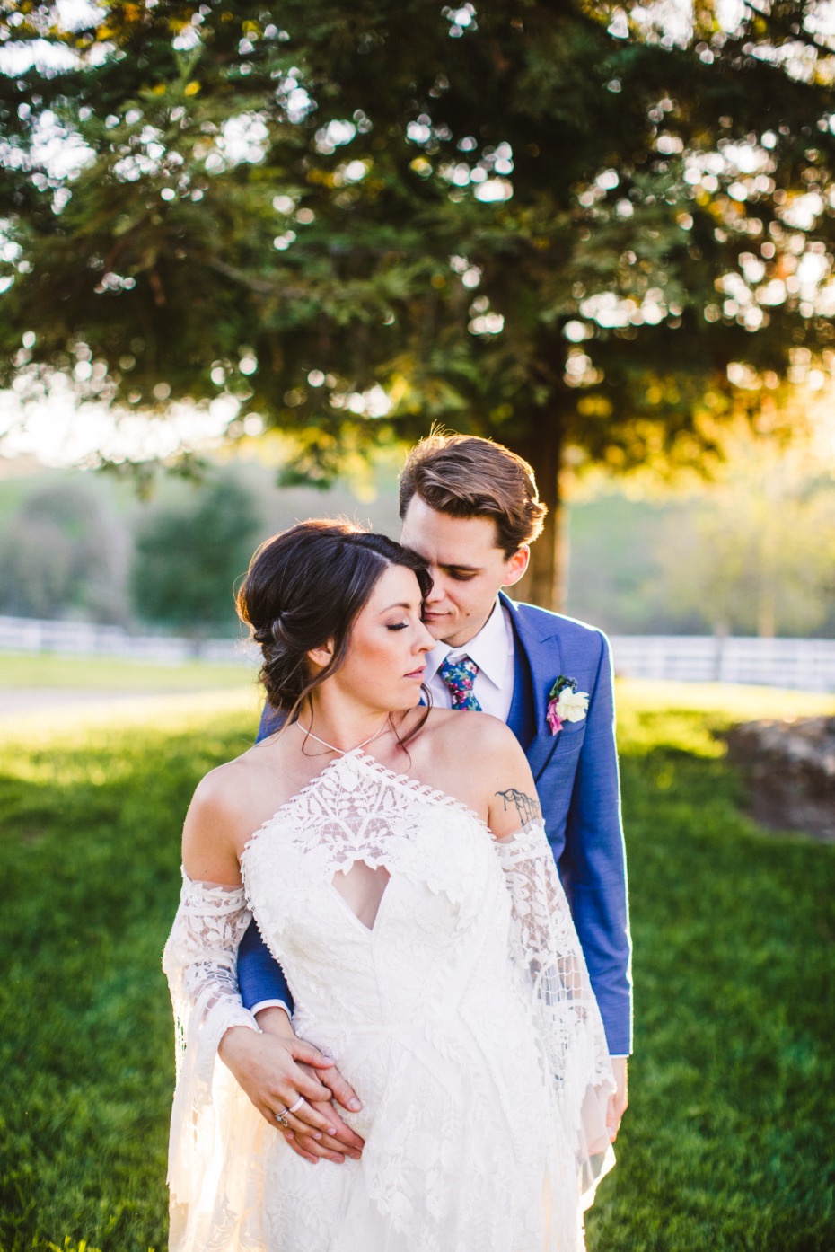 Bride and groom embrace on their wedding day outdoors