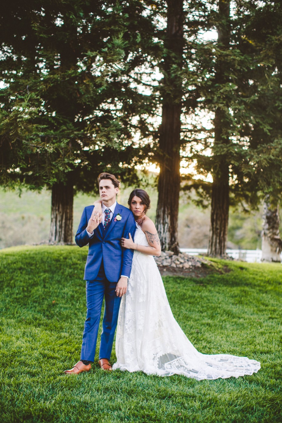 Happy couple posing outdoors in wedding attire