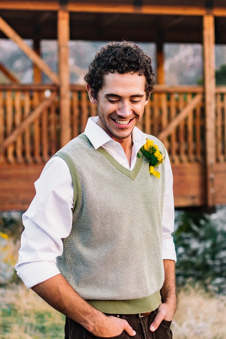 Smiling groom with a sunflower boutonniere outdoors