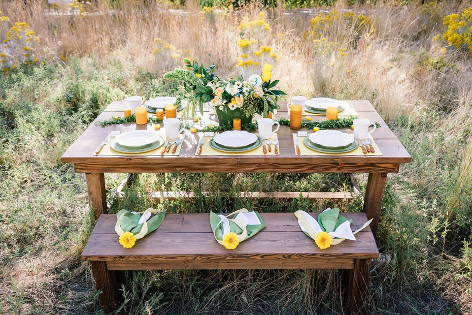 Outdoor dining table with floral decor and yellow accents