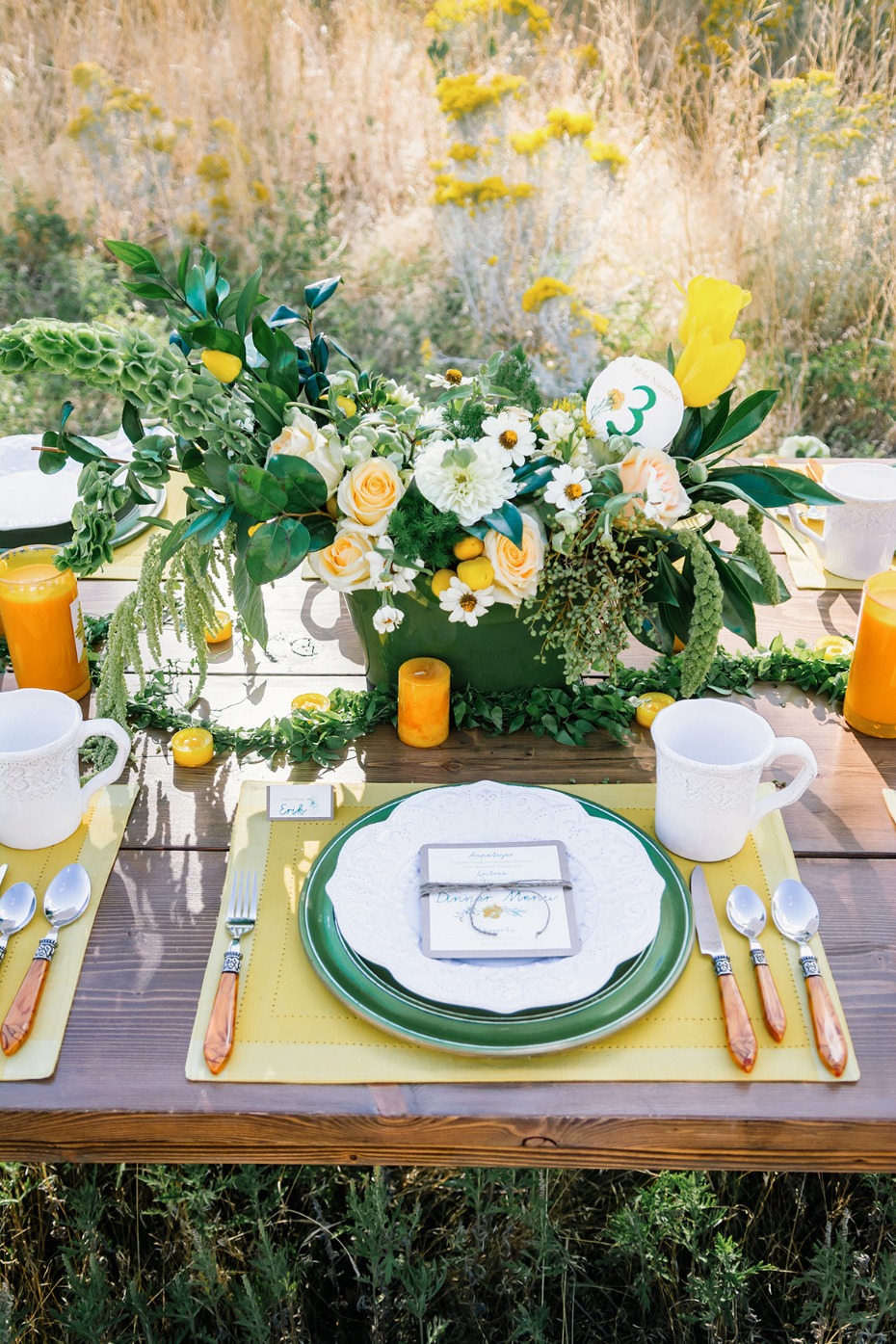 Elegant outdoor table setting with floral centerpiece