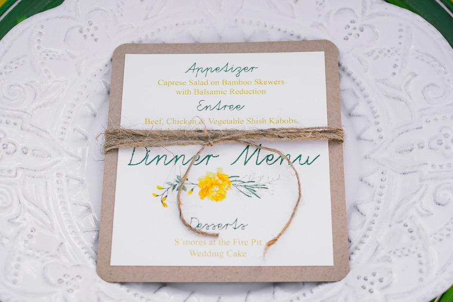 Wedding dinner menu with floral design and twine tie