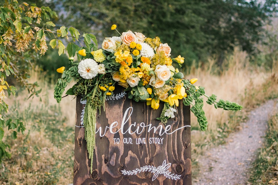 yellow and green floral decorated wedding sign