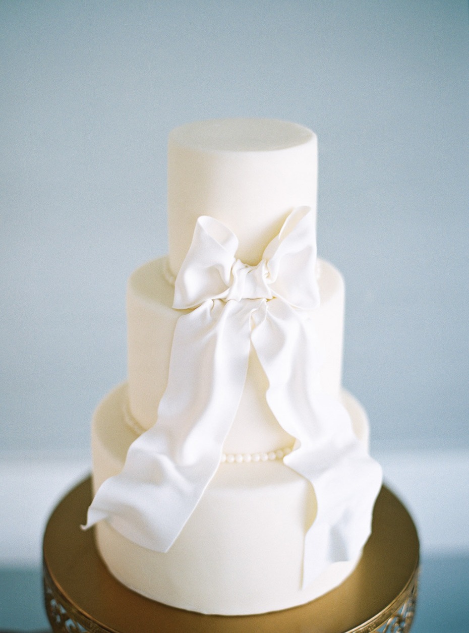 Elegant three tier wedding cake with white bow detail