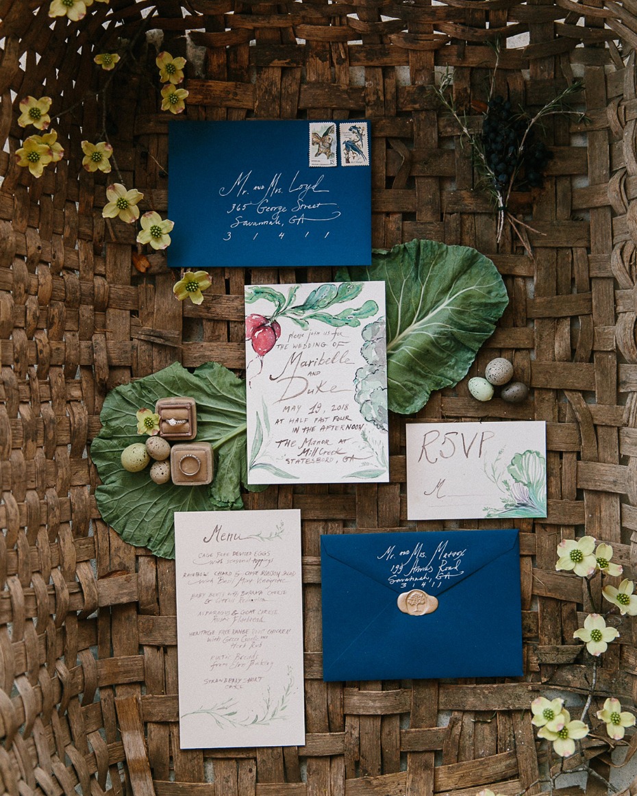 Wedding invitation suite with rings and floral accents