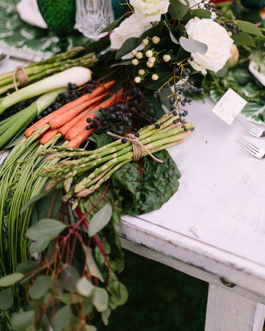Elegant table setting with fresh vegetables and white roses