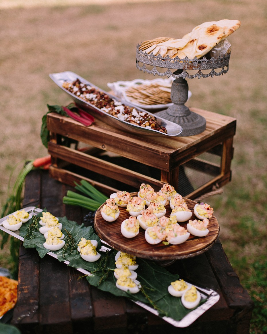 Outdoor buffet with deviled eggs pita bread and salad