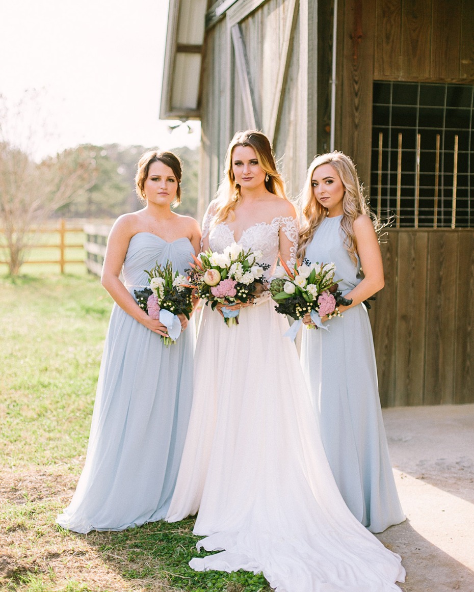 Bride and bridesmaids in pale blue dresses outdoors